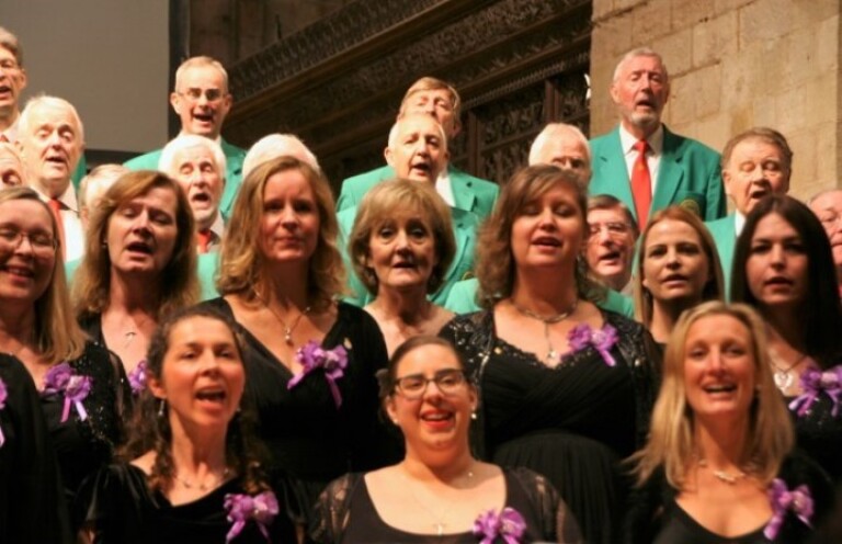Close up if the military wives performing with the romsey male voice choir in the background.