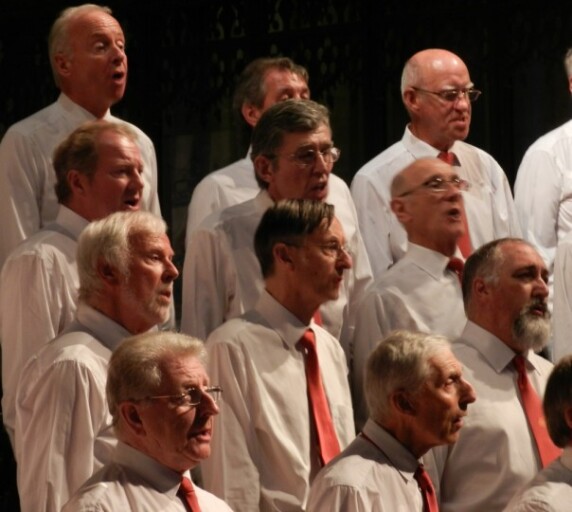 Too hot for the green jackets. Concert organiser Mike Bull second row extreme left.